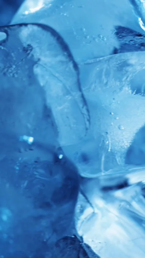 Vertical macro of blue ice cubes with varied movement for drink cooling, re.. Stock Footage 345360624