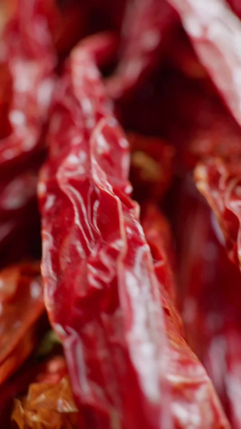 Vertical macro bunches of dried red chili peppers hanging together. Stock-Footage 335115203