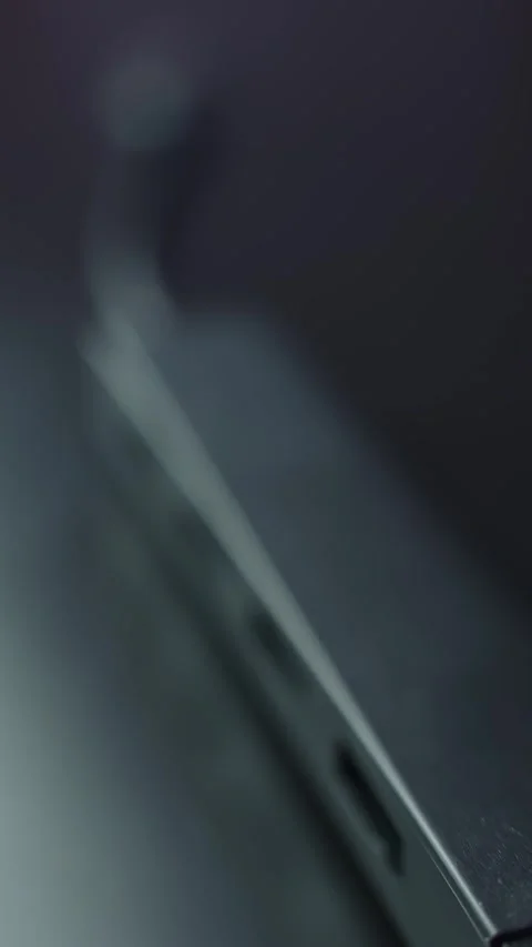 Vertical macro close-up of a black USB hub corner on a desk, shallow depth of Stock Footage 329479547