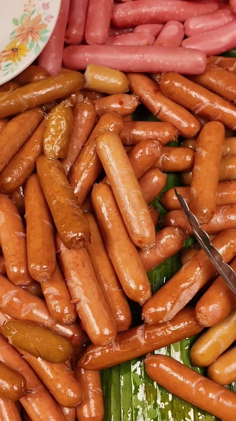 Vertical Macro of Mini Sausages Piled on Banana Leaf Stock Footage 326464610