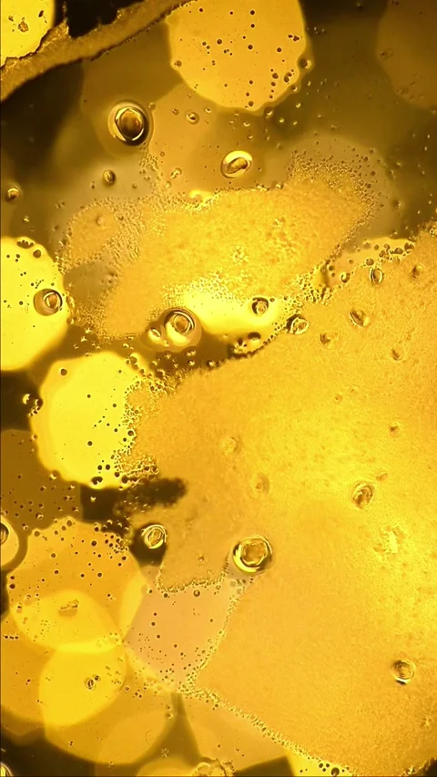 Vertical macro of orange liquid surface freezing into a matte texture Stock Footage 342093364