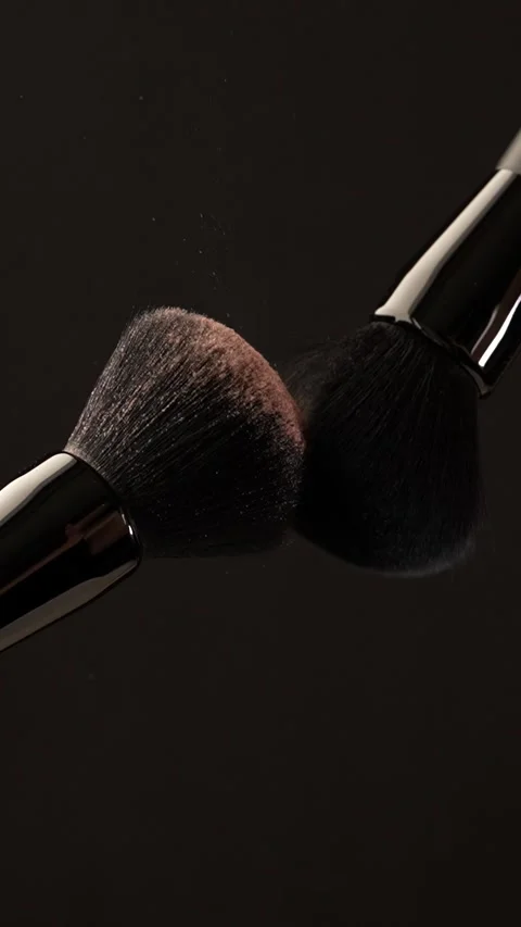 Vertical macro shot of cosmetic brushes touching, with blush, powder or hig.. Stock Footage 312762387
