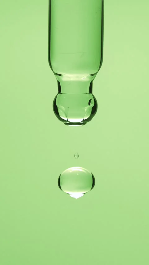 Vertical macro shot of a natural aloe vera extract or tea tree oil droplet Stock Footage 339764855