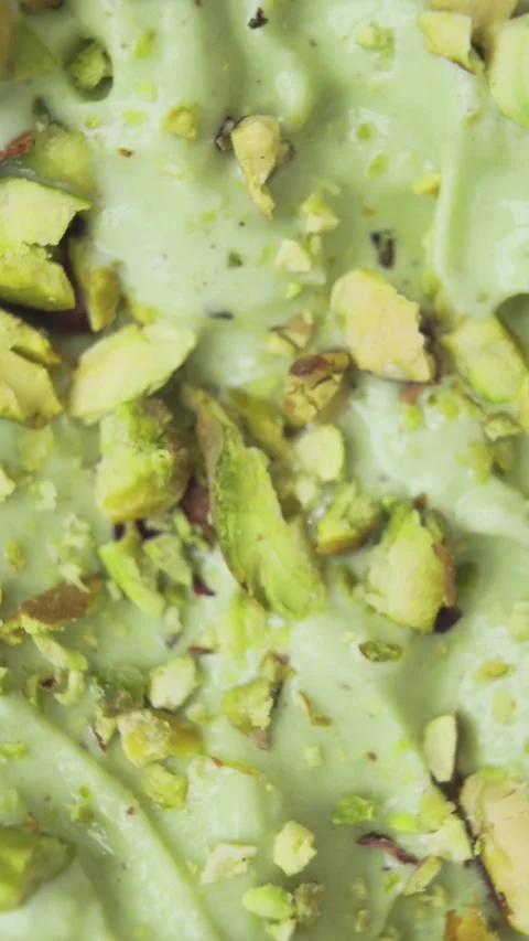 Vertical Macro Shot of Pistachio Ice Cream with Raw Nuts on Top Stock Footage 314656717