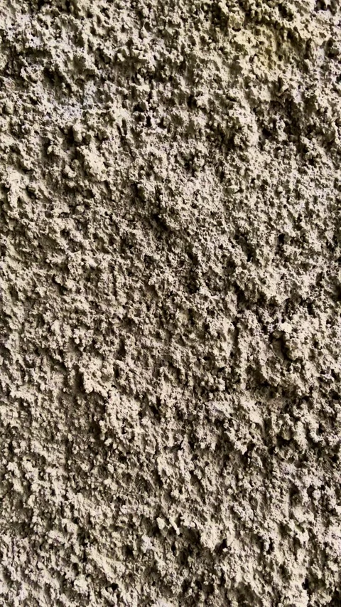 Vertical macro view captures a coarse aged concrete wall with uneven granul.. Stock Footage 340116039