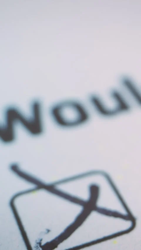 Vertical macro view of a document with a hand drawn checkmark, symbolizing Stock Footage 328699273
