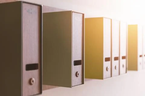 Vertical mailboxes on wall with sunlight Stock Photos
