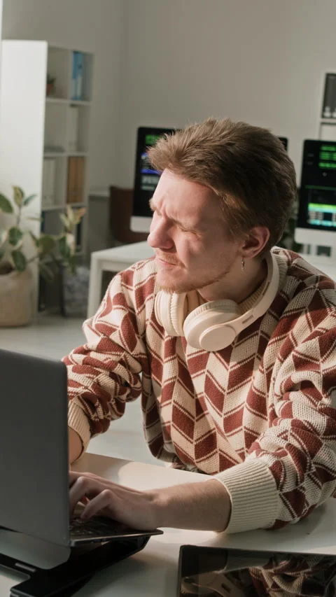Vertical of Male Programmer Looking at Sunshine while Coding on Laptop in Office Stock Footage 330133092