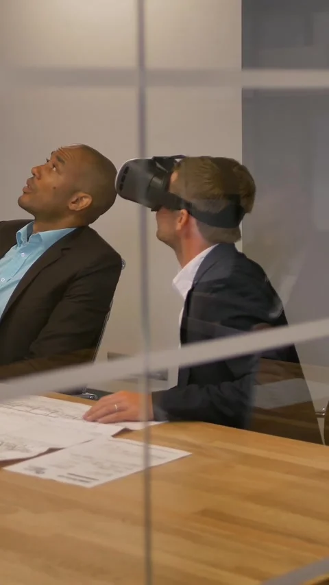 Vertical of Male in VR headset looking at objects in virtual reality with Stock Footage 277274786