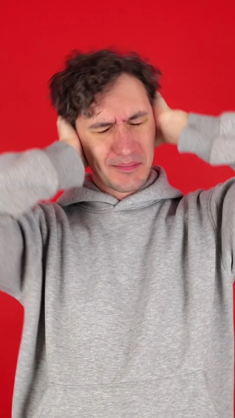 Vertical man covers ears palms, does not want to listen to screams Stock Footage 304761612