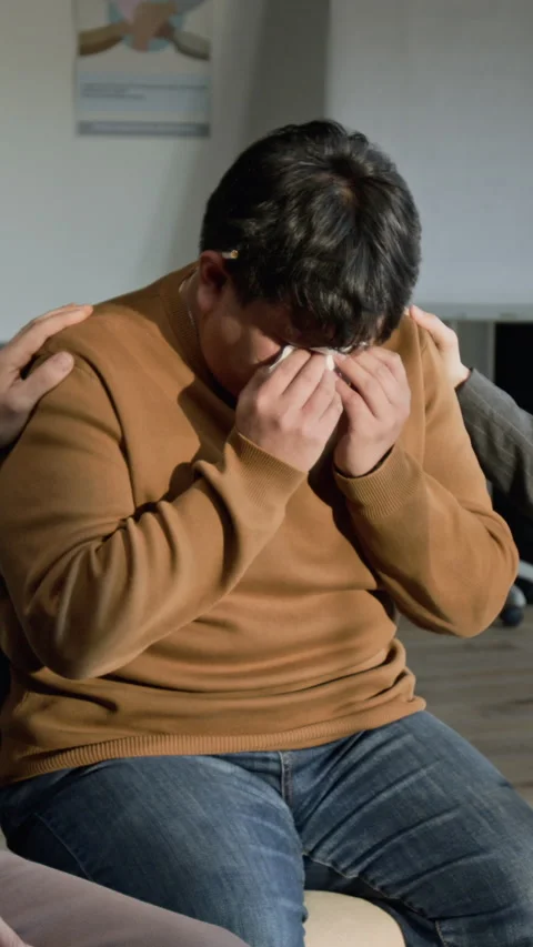 Vertical of Man Crying during Therapy Session with People Comforting Him Stock Footage 337233098