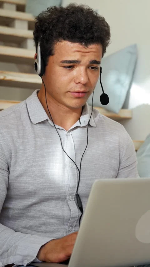 Vertical of Man in headset speaks at online teaching via zoom room Stock Footage 276626962