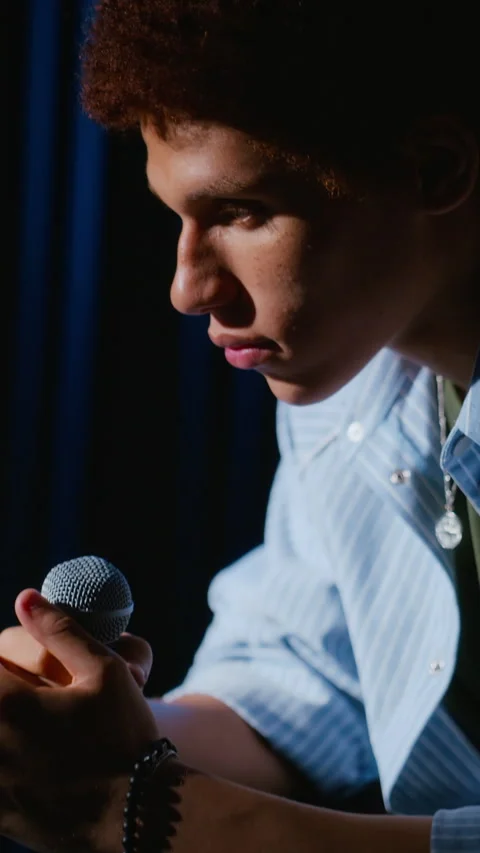Vertical of Man Holding Microphone before Performing on Theater Stage Stock Footage 344533944