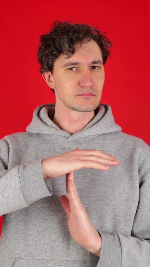 Vertical man holds his hands in front of shows sign timeout gesture. Stock Footage 304761740