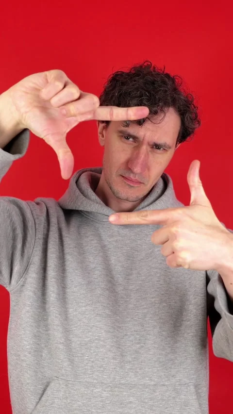 Vertical man making photo frame gesture hands, filled creativity imagination 動画素材 304761138