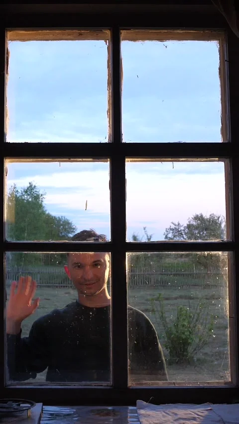 Vertical man opens old wooden shutters outside old house. gesture of greeting Stock Footage 276239674