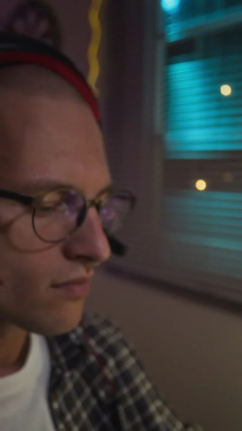 Vertical of Man Putting on Headset and Playing Video Games at Night Stock Footage 342024983