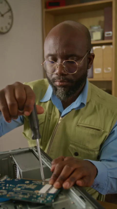 Vertical of Man Repairing Desktop PC Using Screwdriver Stock Footage 341430745