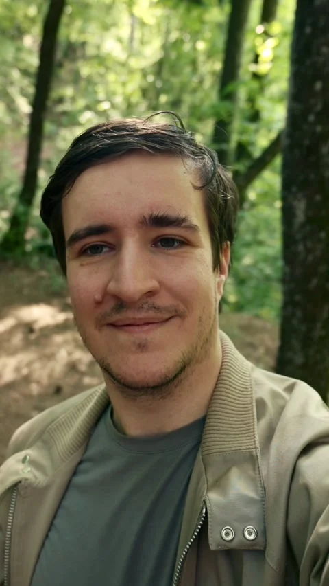 Vertical of Man Taking Selfie in Forest Stock Footage 274144679
