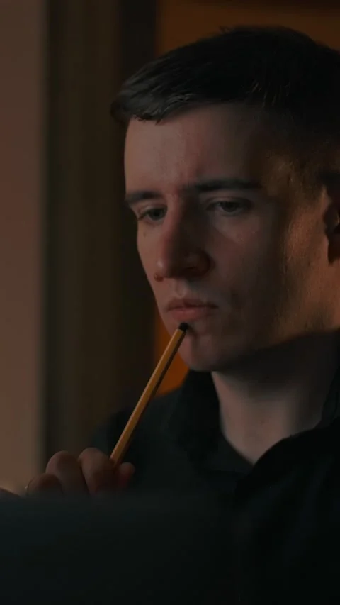 Vertical of A man teaches a lesson, thinks and makes a note in a text tablet Stock Footage 276935218