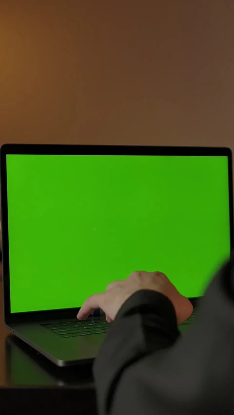 Vertical of Man in VR helmet working at home behind laptop with green screen Stock Footage 276932064