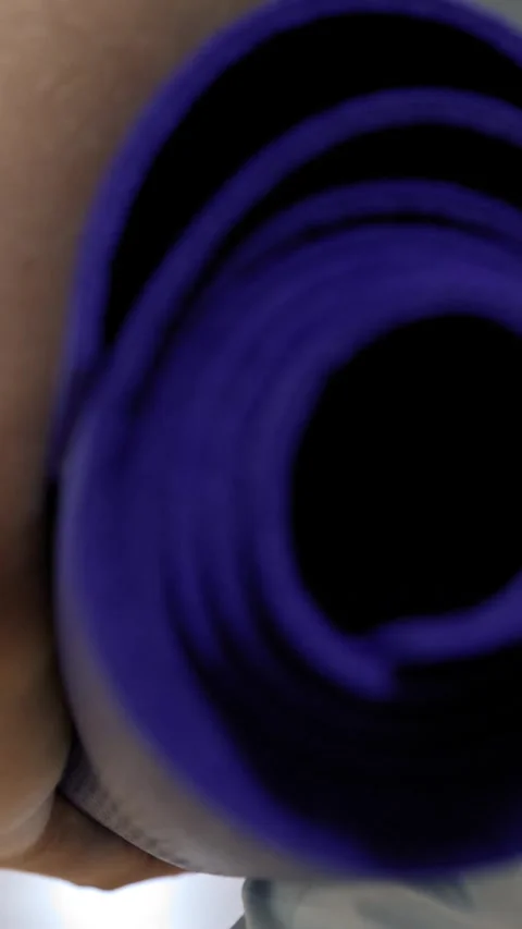 Vertical of Man walks into big hall holding blue mat roll for yoga class Stock Footage 275623835