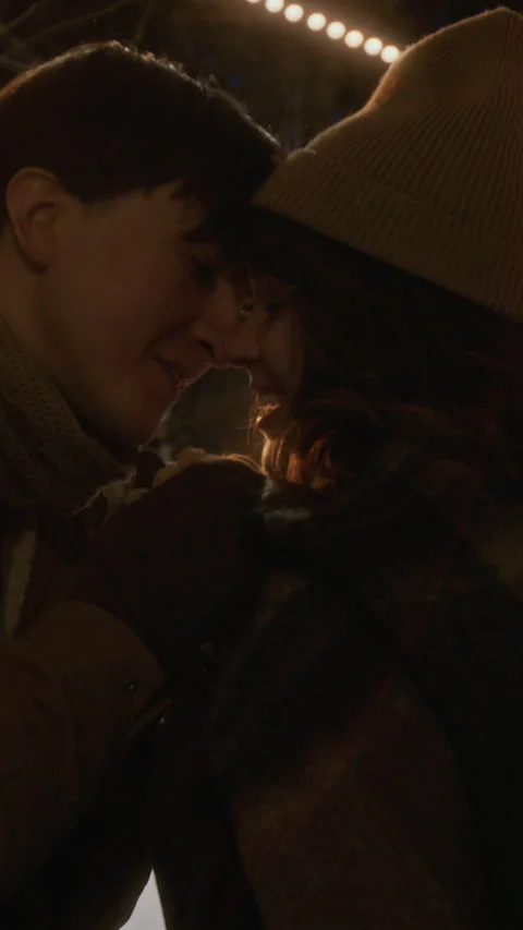 Vertical of Man Warming Hands of Woman on Romantic Winter Night Date Stock Footage 342015730