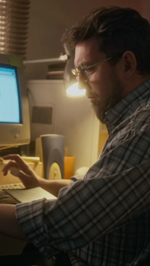 Vertical of Man Working on Spreadsheet Report on Retro Computer Stock Footage 327240639