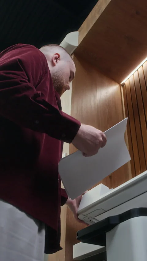 Vertical of Manager Doing Copies of Documents on Printer at Office Video stock 312854956