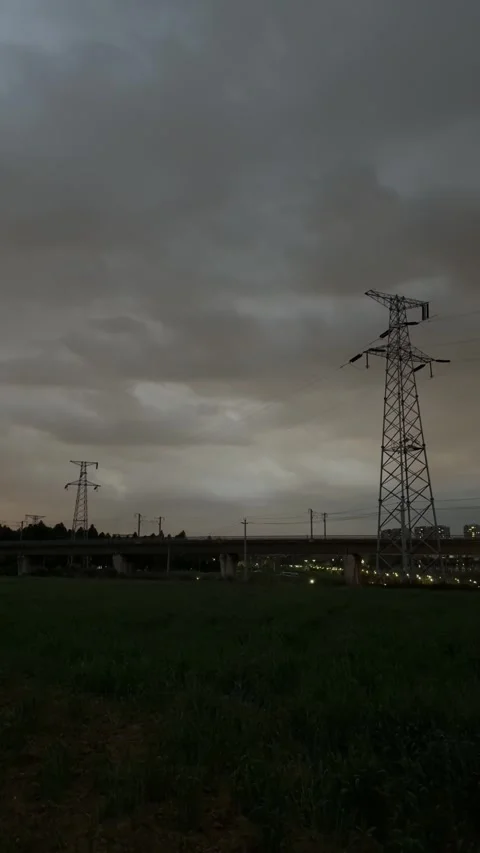 Vertical Massive Electricity Pylon and HighSpeed Railway Track at Night in C 動画素材 334696558