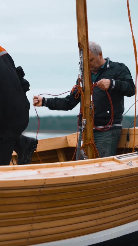 Vertical of Master and his assistant work on wooden sailboat Stock Footage 305514157