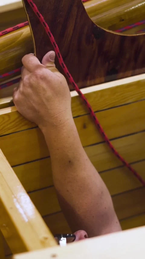 Vertical of Mature master working with newly homemade wooden sailboat in Stock Footage 305460449