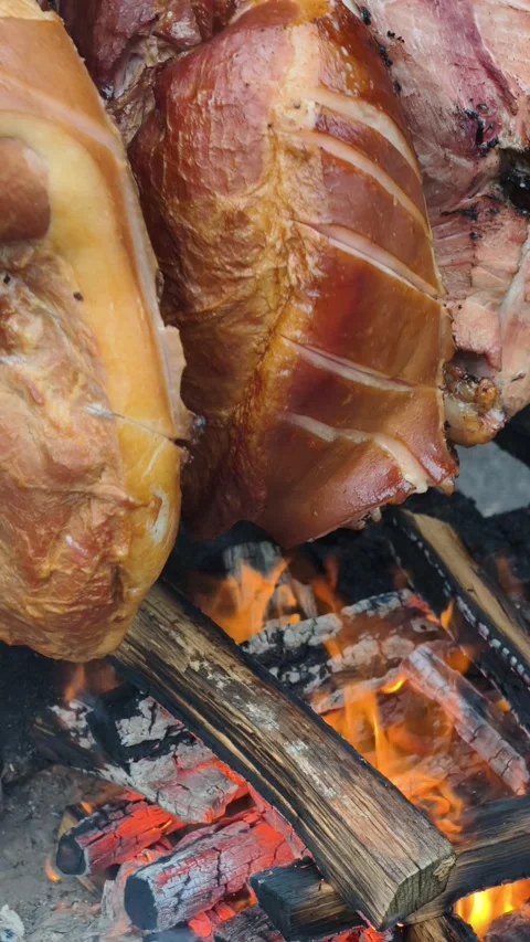 Vertical Meat Roasting Over Open Wood Fire Rustic BBQ Cooking 4K Stock Footage 332162838