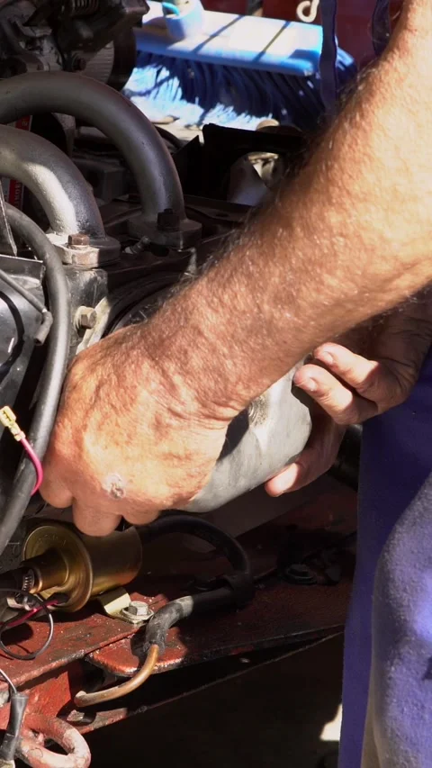Vertical mechanic working on engine of classic car. Detailed process maintenance Stock Footage 309240084