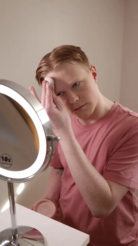 A Vertical Medium Shot Of A Man Applying Powder Makeup Mirror Beauty Routine Stock Footage 309903796