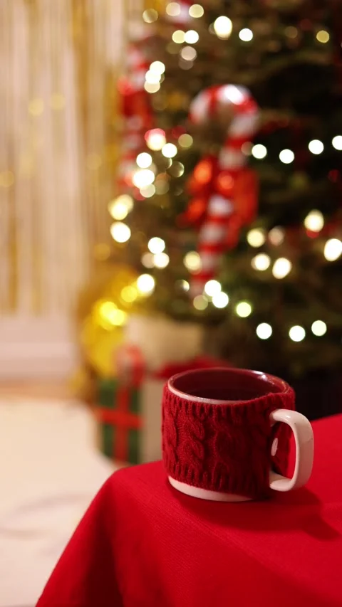 A Vertical Medium Shot Of A Red Mug With Knit Sweater On Holiday Table Stock Footage 313707801