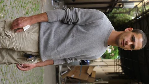 Vertical medium shot of serious and proud young man in courtyard Stock Footage 277194004