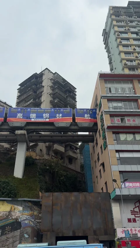 Vertical Medium-Wide Shot of Chongqing Liziba Monorail Train Passing Directly Stock Footage 345648609