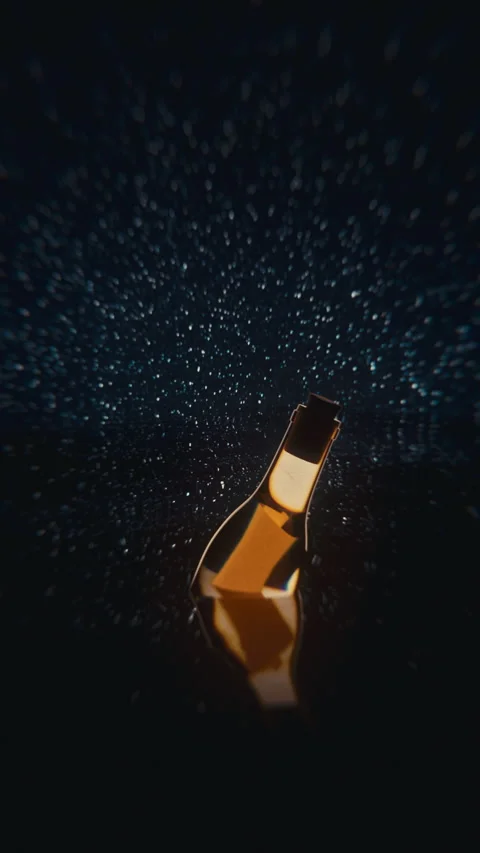 Vertical message in a bottle drifting in starry ocean — 4K dreamy loop Stock Footage 320625595