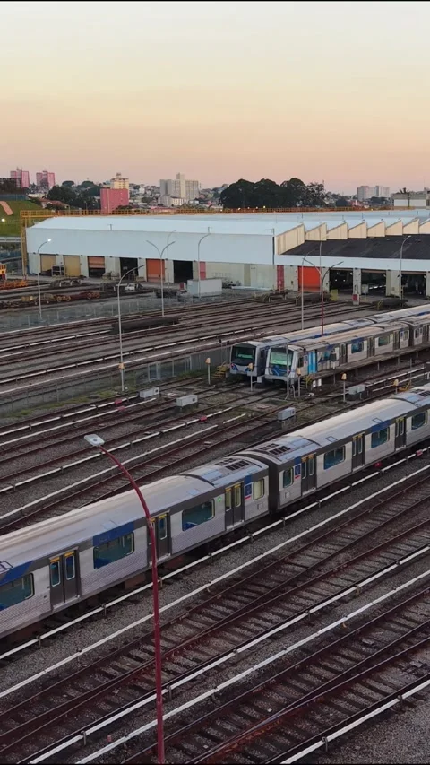Vertical Metro Train Moving Through Railway Depot at Sunset Stock Footage 340536913