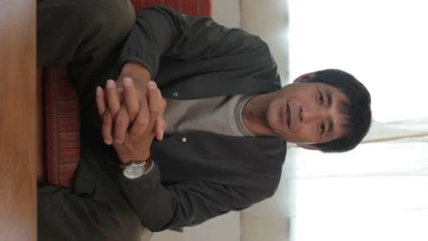 Vertical : Middle aged asian man talking to the camera. Stock Footage 224902177