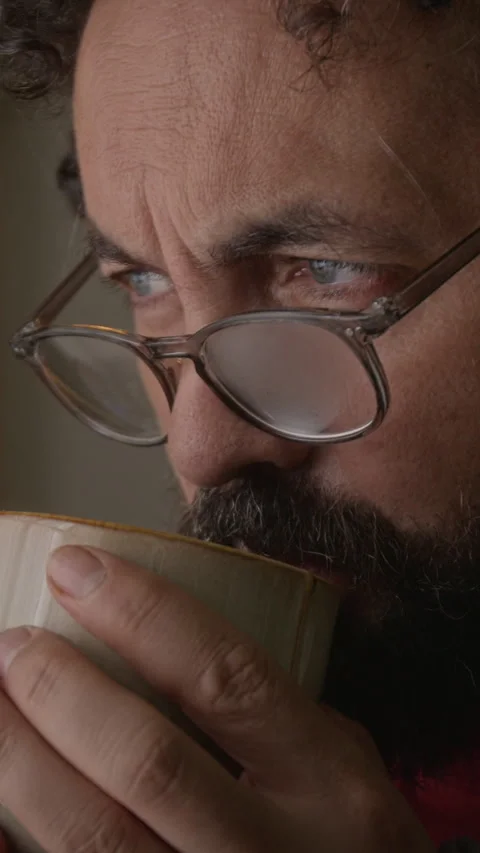 Vertical of Middle Aged Man Sipping Hot Coffee and Thinking Deeply on Break Stock Footage 341675163