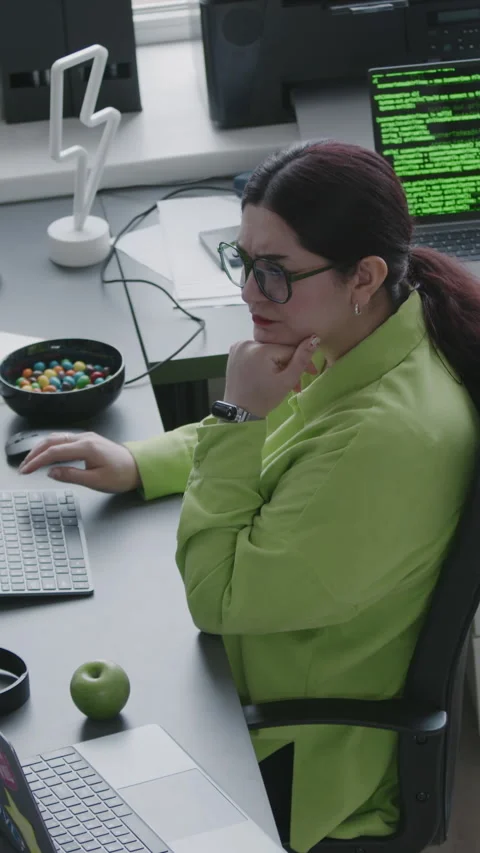 Vertical of Middle Eastern Woman Coding on Computer in Office Stock Footage 276400457