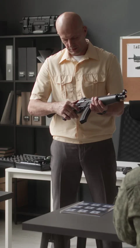 Vertical of Military Instructor Explaining Elements of Machine Pistol Video stock 259293713