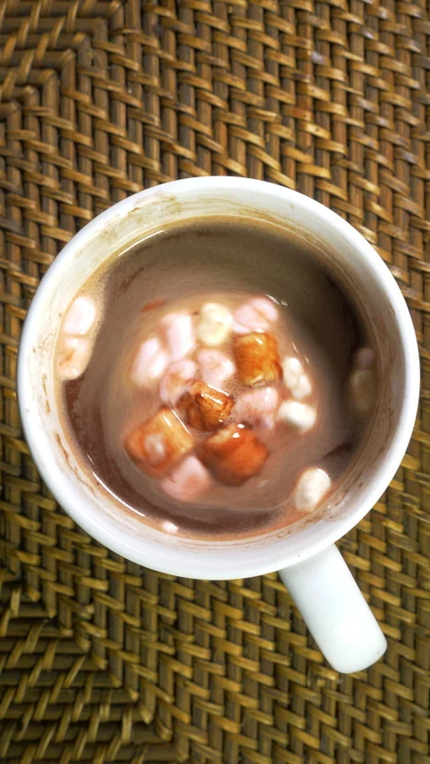 Vertical - Mini marshmallows floating on a cup of cocoa, hot chocolate or coffee Stock Footage 301792304