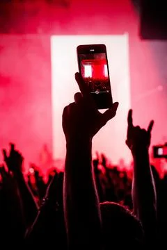Vertical mobile background of fan recording concert with copy space Stock Photos