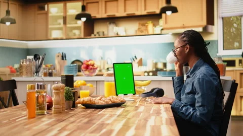 Vertical mockup green screen on tablet in kitchen at wooden table Stock Footage 344245412