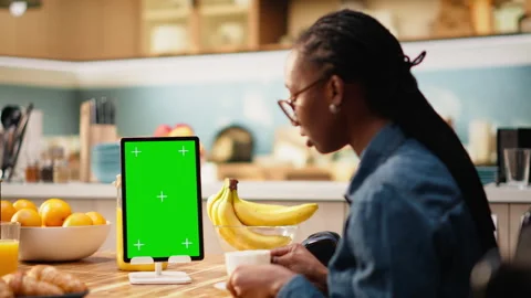 Vertical mockup green screen on tablet in kitchen at wooden table Stock Footage 344248070