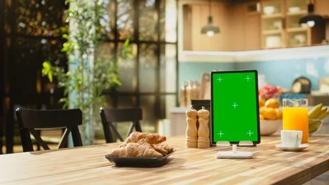 Vertical mockup screen on tablet in empty rustic kitchen with natural light Stock Photos