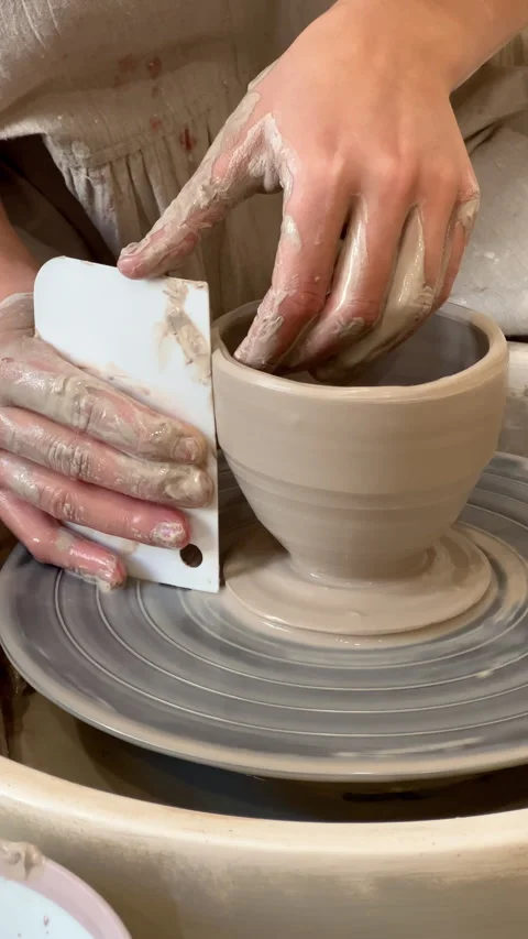 Vertical: Modeling pottery with clay on pottery wheel. Closeup cercamic workshop Video stock 280779602